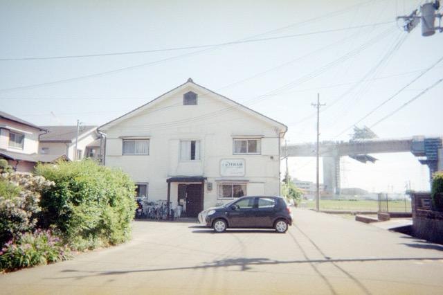 Film photo: a quiet house under a pale sky